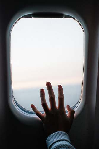 car mirror person touching airplane window mirror